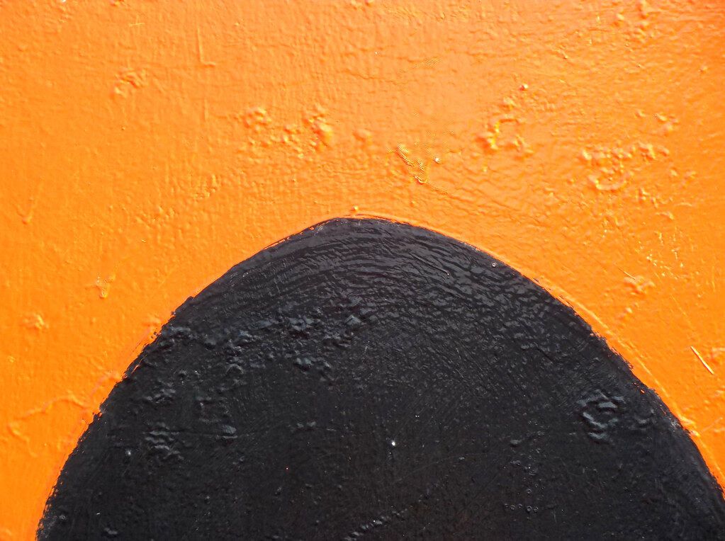 Orange as orange, with a black arch at the bottom that the eye passes over.