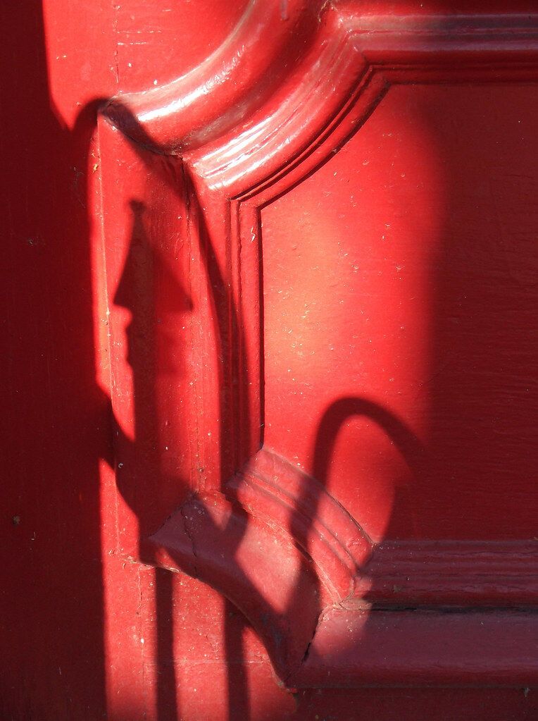 A red door in low sun.