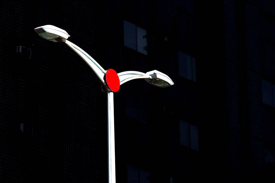 A red lamp on a black ground. Noticed, it’s “a light.” Seen, it’s red against black.