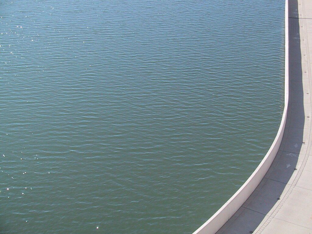 Calm water against a curved edge.