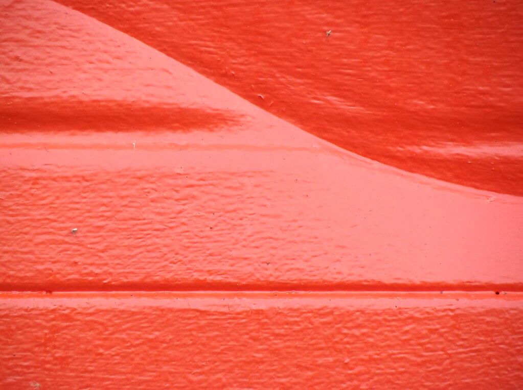 A red-orange wall, softly curved.
